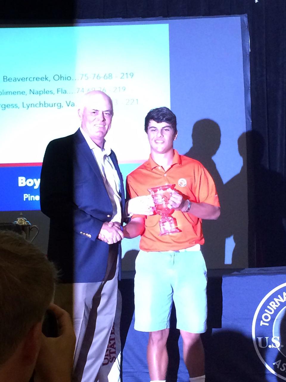 Nick Solimene, 17, of Naples, accepts the bronze trophy after tied for third in the U.S. Kids Golf teen world championship.