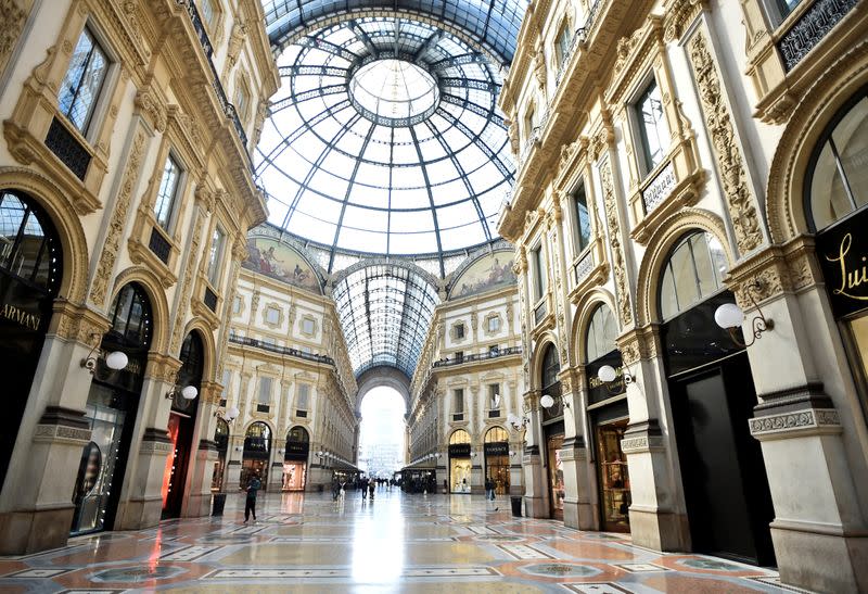 FILE PHOTO: People walk in Galleria Vittorio Emanuele II, after the Italian government imposed a virtual lockdown on the north of the country, in Milan