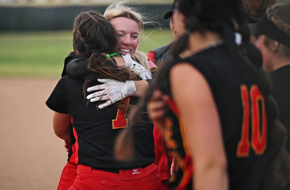 Oakdale’s Bailey Peterson gets a hug from teammate Raegen Everett (7) after making the game winning hit in the 8th inning during the Valley Oak League game with Kimball in Oakdale, Calif., Thursday, May 4, 2023.
