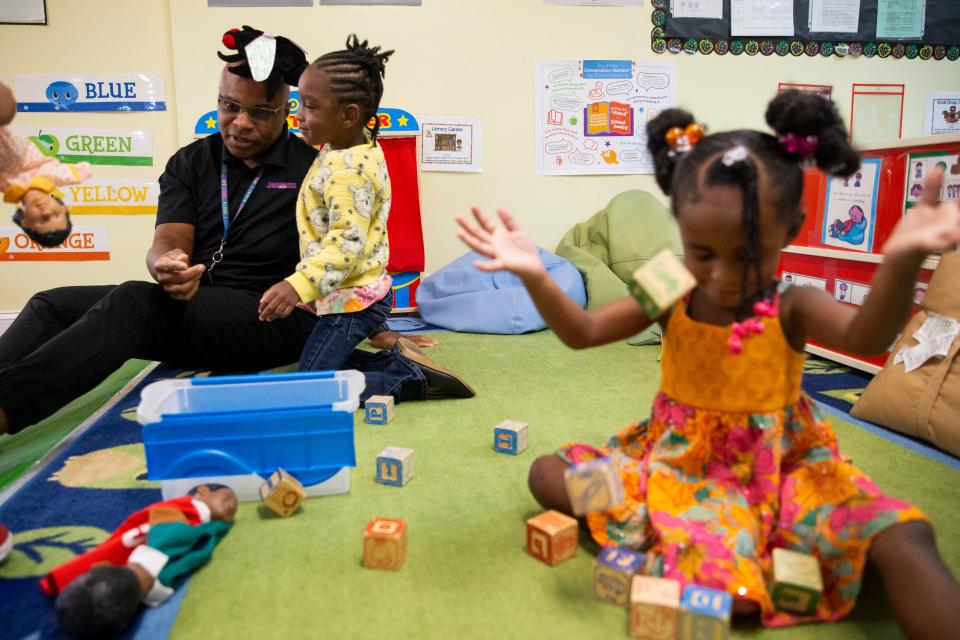 Eric Harris, the founder of Equity 2 Prosperity, talks to Harmonee, 3, as she lands a fly puppet on his head while other children play during the Equity to Prosperity program in Memphis, Tenn., on Thursday, September 7, 2023.