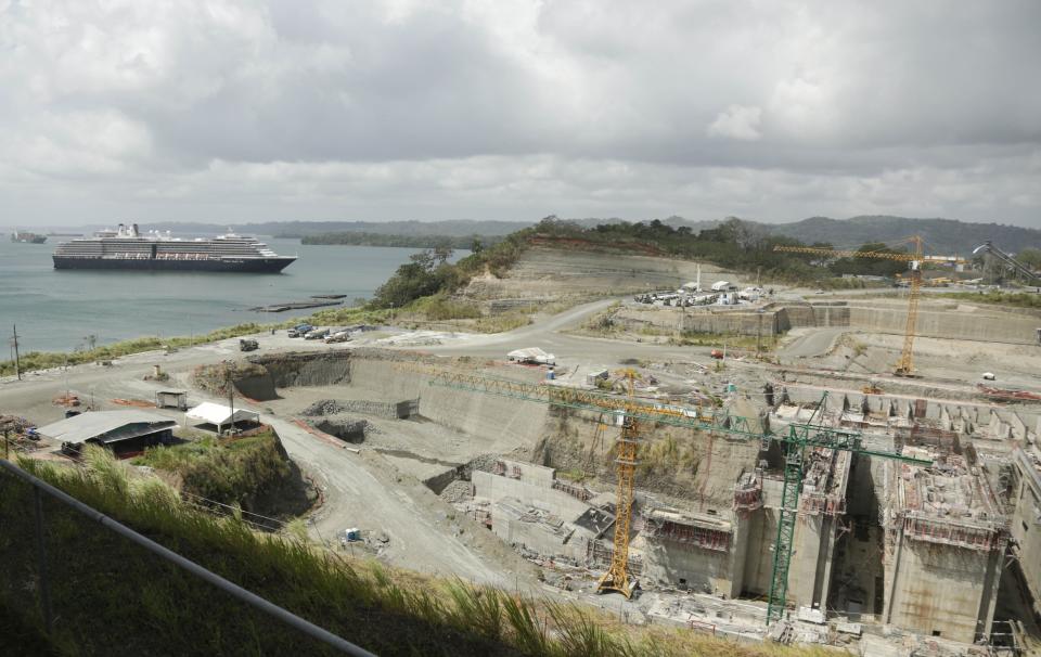 The Panama Canal expansion project sits idle as a cruise ship navigates to the Gatun Locks in Gatun, Panama, Thursday, Feb. 20, 2014. The canal expansion project remained idle after the administrator of the Panama Canal said Wednesday that work would resume Thursday after it was halted over a disagreement with a contractor on cost overruns. (AP Photo/Arnulfo Franco)