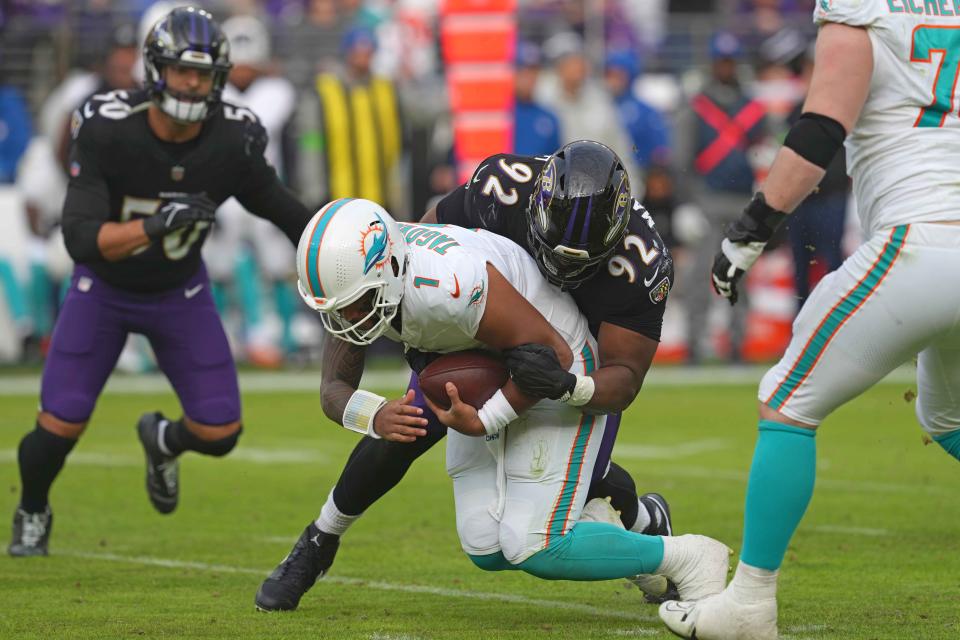 Dec 31, 2023; Baltimore, Maryland, USA; Baltimore Ravens tackle Justin Madubuike (92) sacks Miami Dolphins quarterback Tua Tagovailoa (1) during the third quarter at M&T Bank Stadium. Mandatory Credit: Mitch Stringer-USA TODAY Sports