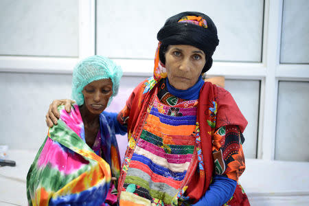 Saida Ahmad Baghili sits next to her relative at the al-Thawra hospital. After the war began, Baghili's condition deteriorated with her family lacking the money for treatment. She lost more weight and in the last two months developed diarrhoea. REUTERS/Abduljabbar Zeyad