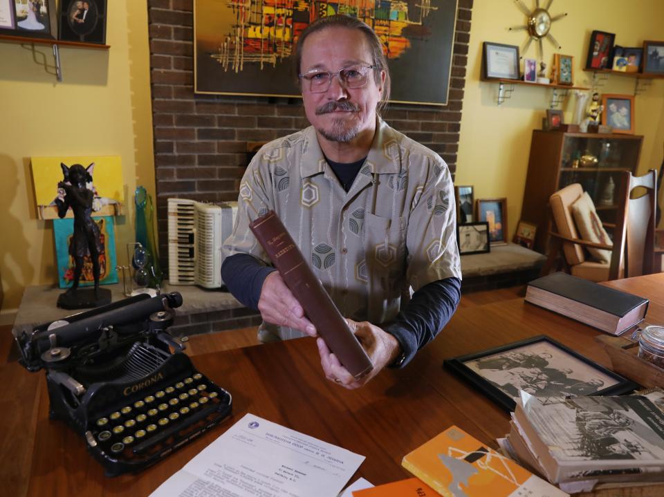 Nick Rozanov holds a rare first edition of Karl Marx's Das Kapital, a book that was part of his father's collection. Rozanov keeps the book in a safe deposit box.