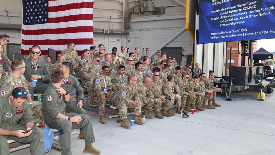 The William Tell teams watch the F-15 weapons loading competition. <em>James Deboer</em>