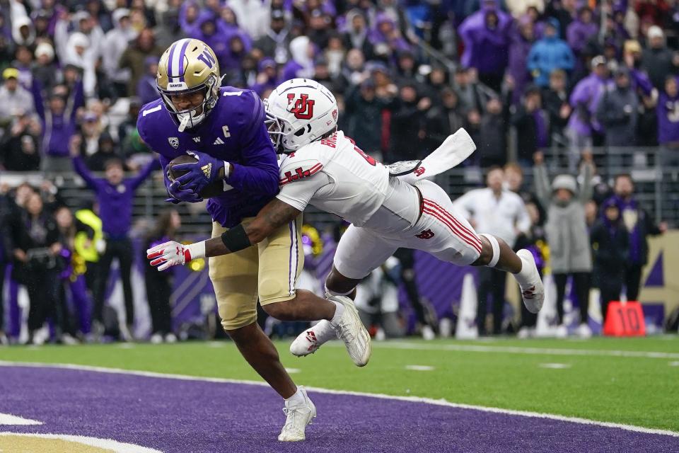 Washington wide receiver Rome Odunze (1) makes a catch for a touchdown against Utah cornerback JaTravis Broughton (4) during the second half of an NCAA college football game Saturday, Nov. 11, 2023, in Seattle. | Lindsey Wasson, Associated Press