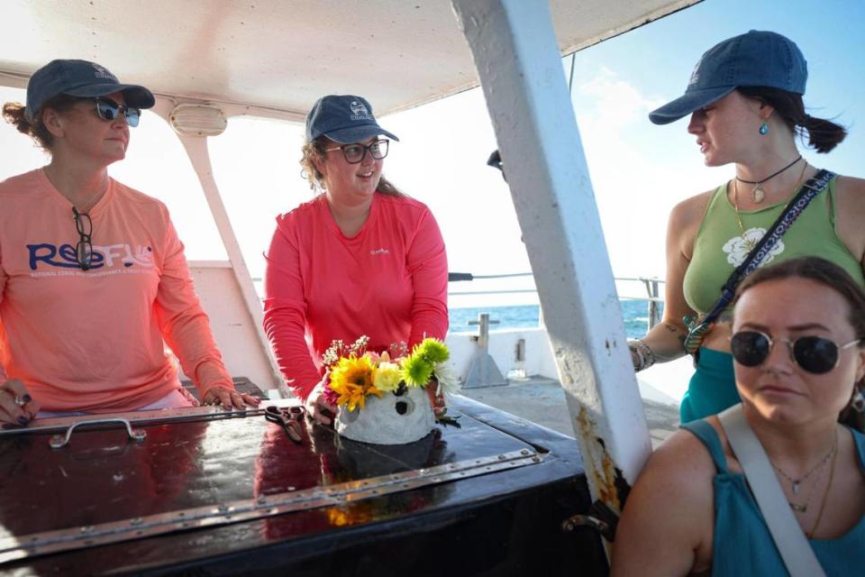 From left: Debbie Pace, Haylea Bettmann, Lexi Pace, and Mackenzie Pace create a tribute reef, a smaller version of the reef ball in which Jeffrey Neil Pace’s ashes were laid to rest.