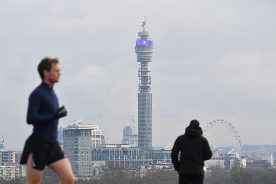 A jogger runs in Primrose Hill park with the BT Tower on the skyline in London on January 12, 2021 as life continues under Britain's third lockdown since the start of the coronavirus pandemic. - People who flout coronavirus lockdown rules are putting lives at risk, the British government said on Tuesday, as cases surge to record highs and rumours swirl of potentially tougher restrictions. (Photo by JUSTIN TALLIS / AFP) (Photo by JUSTIN TALLIS/AFP via Getty Images)