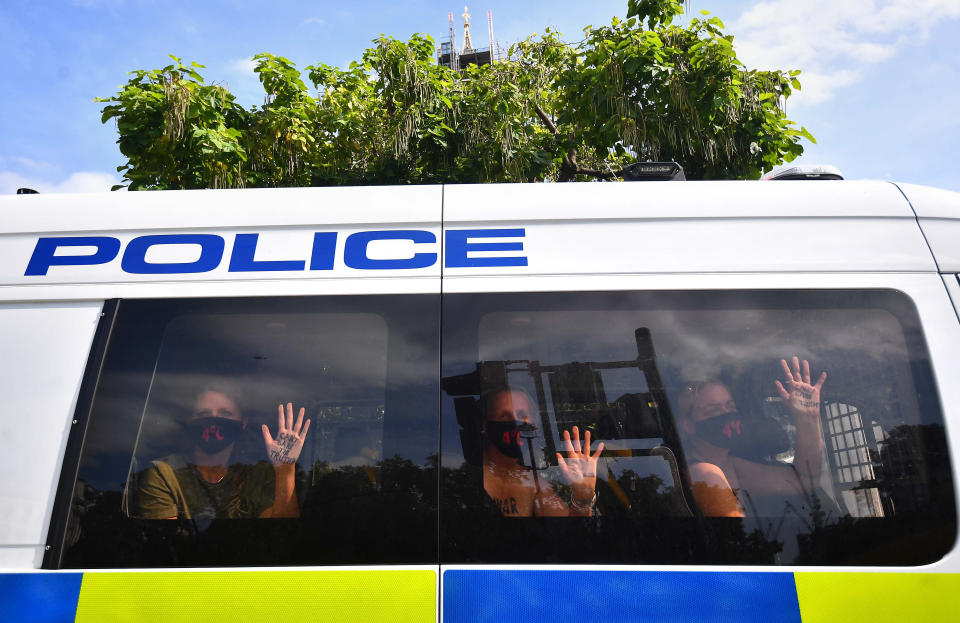 Extinction Rebellion protesters in a police van outside the Houses of Parliament, London, on the last day of demonstrations.