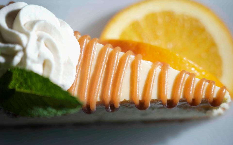 The saffron cheesecake at The Cheel is topped with caramel, house-made whipped cream and mint leaves.