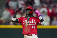 Cincinnati Reds' Elly De La Cruz gestures to teammates after hitting an RBI ground-rule double during the sixth inning of the team's baseball game against the Philadelphia Phillies in Cincinnati, Wednesday, April 24, 2024. (AP Photo/Aaron Doster)