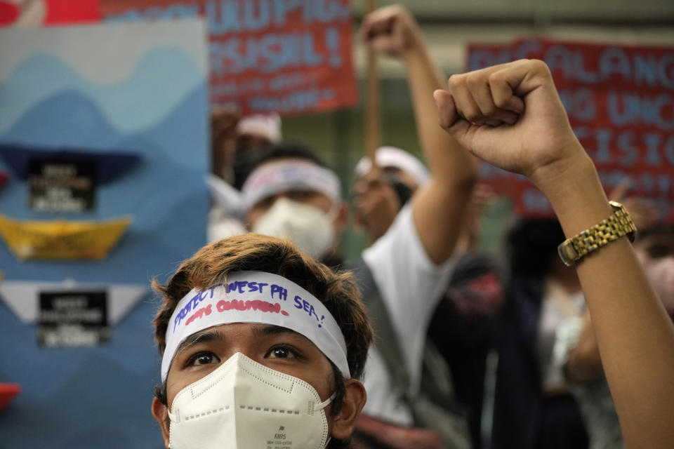 Protesters shout slogans to mark the 6th anniversary of the issuance of the 2016 decision by an arbitration tribunal set up under the U.N. Convention of the Law of the Sea after the Philippines complained against China's increasingly aggressive actions in the disputed sea during a rally outside the Chinese consulate in Makati, Philippines, Tuesday, July 12, 2022. U.S. Secretary of State Antony Blinken renewed a call to China to comply with a 2016 arbitration ruling that invalidated Beijing's vast claims in the South China Sea and warned that Washington is obligated to defend treaty ally Philippines if its armed forces, public vessels or aircraft come under attack in the disputed waters. (AP Photo/Aaron Favila)