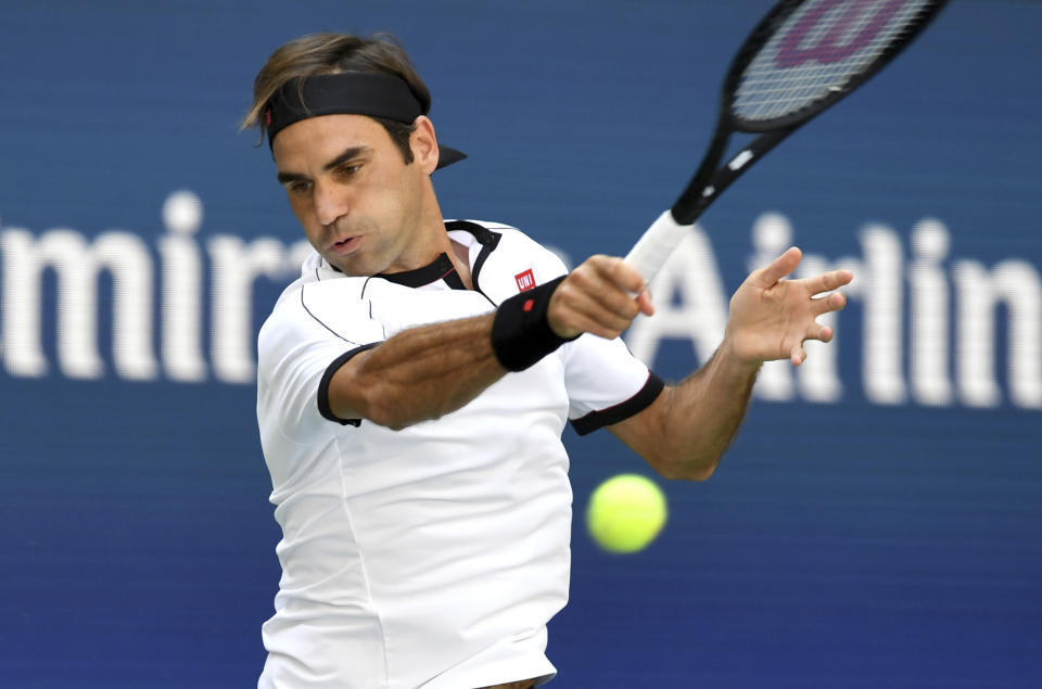 Roger Federer, of Switzerland, returns a shot to Daniel Evans, of the United Kingdom, during round three of the US Open tennis championships Friday, Aug. 30, 2019, in New York. (AP Photo/Sarah Stier)