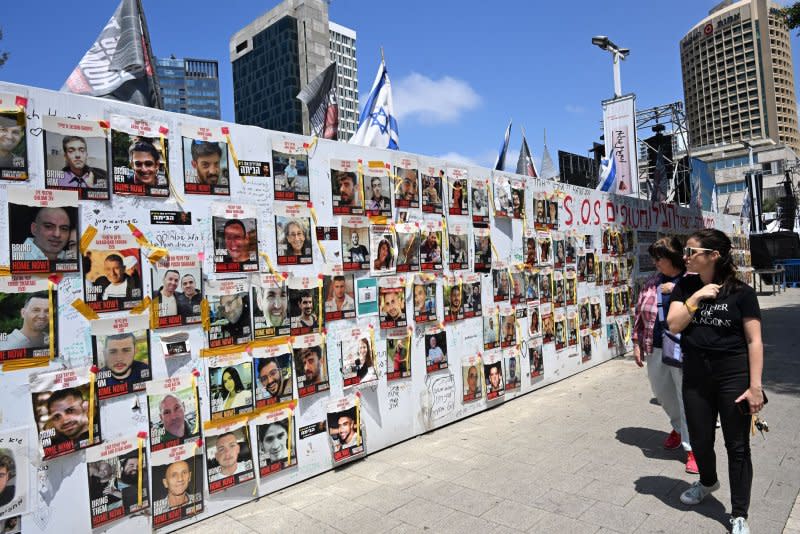 People in April walk past photos of Israeli hostages held captive in Gaza by Hamas in Tel Aviv's Hostage Square. Hama kidnapped about 240 hostages on Oct. 7 and killed about 1,200 individuals, but it is unclear how many of the roughly 130 remaining hostages remain alive. File Photo by Debbie Hill/ UPI