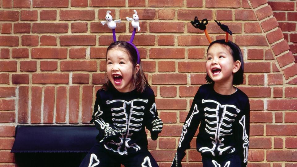 young girls in skeleton costumes