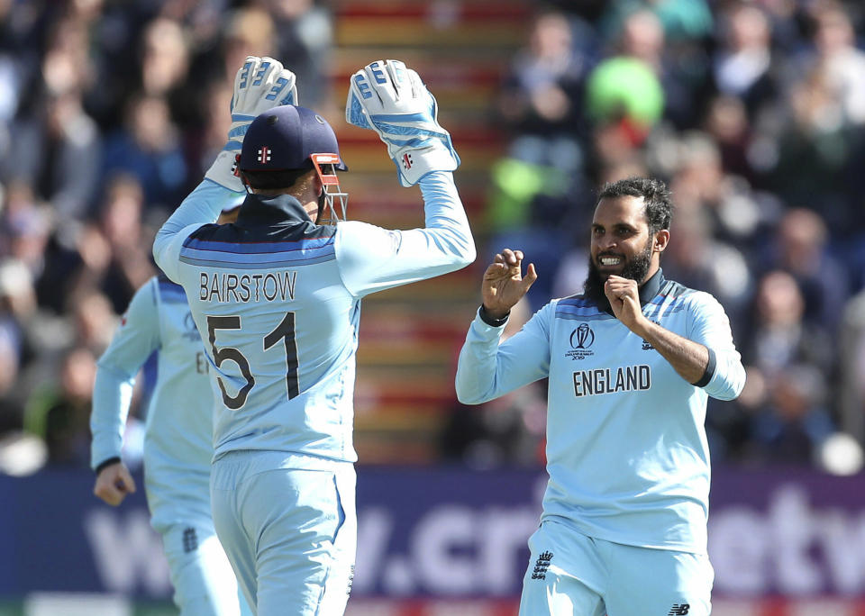 England's Adil Rashid, right celebrates with teammate Jonny Bairstow after the catch of Bangladesh's Mohammad Mithun during the ICC Cricket World Cup group stage match between England and Bangladesh at the Cardiff Wales Stadium in Cardiff, Saturday, June 8, 2019. (David Davies/PA via AP)