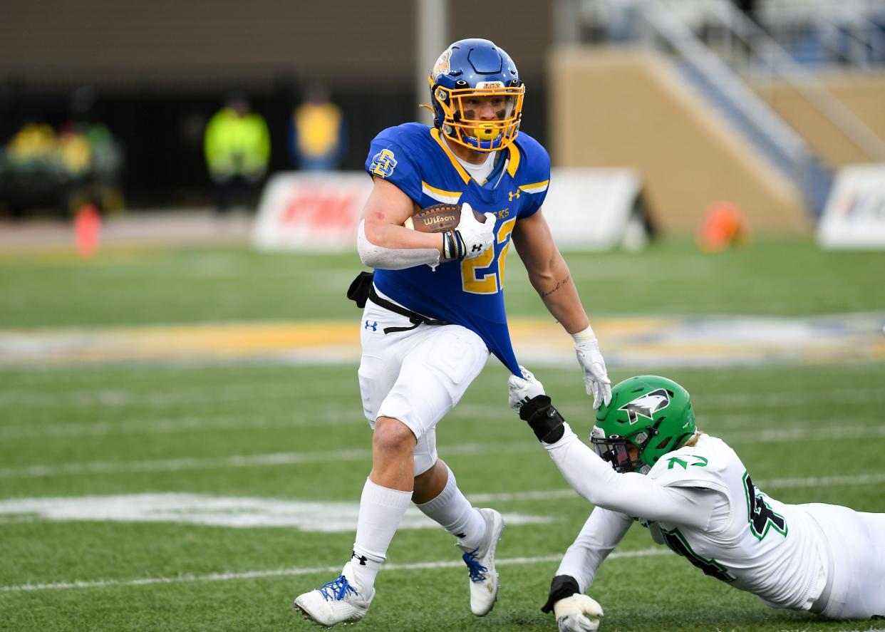 South Dakota State's Isaiah Davis pulls away from a North Dakota defender's tackle attempt on Saturday, November 20, 2021, at Dana J. Dykhouse Stadium in Brookings.