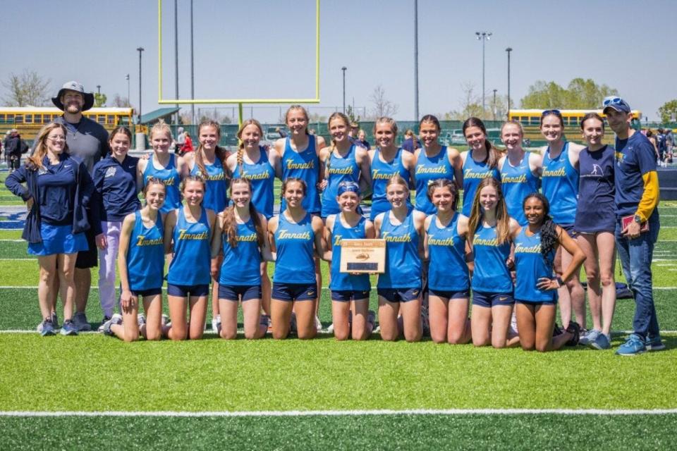 The Timnath girls track & field team celebrates with a team photo after winning the Patriot League title on Saturday, May 4, 2024 in Greeley, Colo.