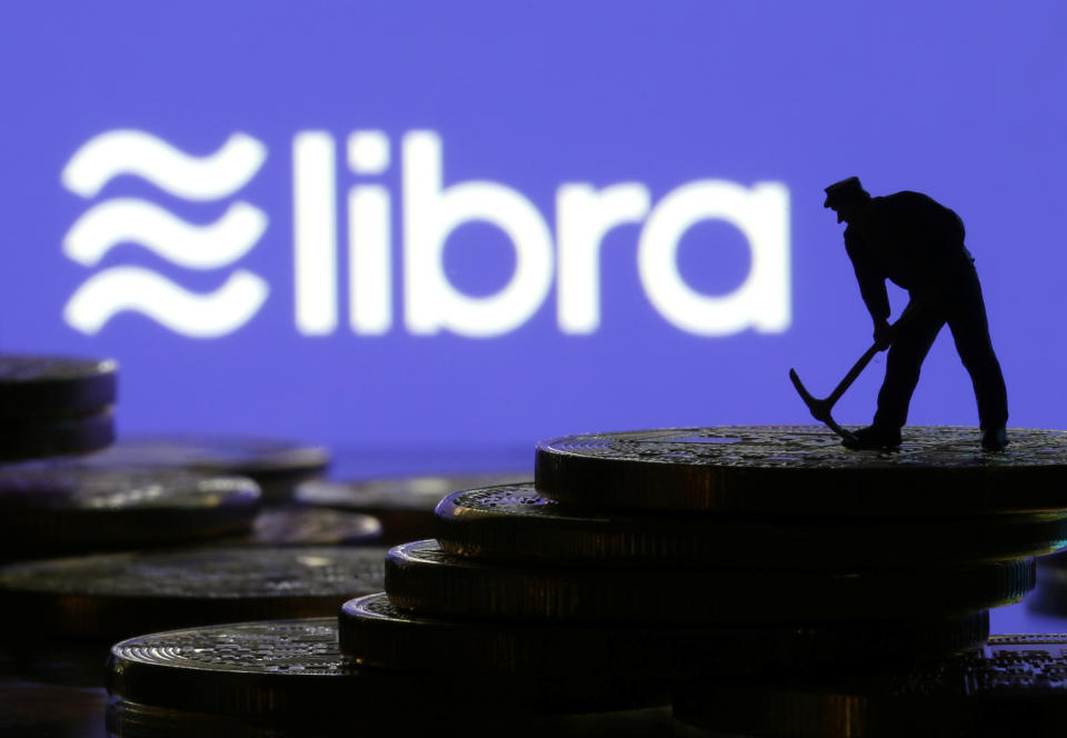 A small toy figure stands on representations of virtual currency in front of the Libra logo in this illustration picture, June 21, 2019. REUTERS/Dado Ruvic/Illustration