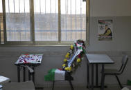 A poster of 17-year-old Palestinian Mohammad Hamayel, and a memorial wreath adorn his classroom in the village of Beita, south of the West Bank city of Nablus. Monday, June 14, 2021. Hamayel was killed during clashes with Israeli forces following a protest against the wildcat Jewish settlement of Eviatar that was established last month without the permission of Israeli authorities on land the Palestinians say is privately owned. (AP Photo/Majdi Mohammed)