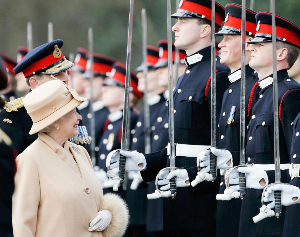 The Queen and Harry share a sweet moment as she inspects soldiers (including her own grandson) at the passing-out Sovereign's Parade at Sandhurst Military Academy in 2006. 