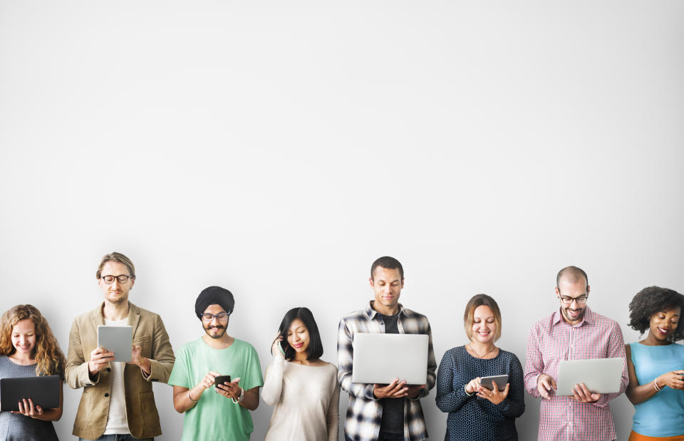 A group of people using mobile devices