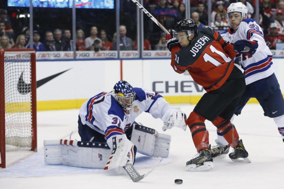 USA goalie Joseph Woll reaches to poke the puck away as Canada's Mathieu Joseph (11) tries to turn with United States' Joseph Cecconi (33) impeding him. Team Canada vs Team USA in 3rd period action of round 1 action of 2017 IIHF Junior championship tournament at Air Canada Centre in Toronto. Canada lost 3-1. Toronto Star/Rick Madonik (Rick Madonik/Toronto Star via Getty Images)