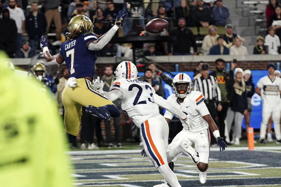 Georgia Tech wide receiver Malachi Carter (7) is unable to catch a pass that was intercepted by Virginia defensive back Coen King, right, during the first half of an NCAA college football game Thursday, Oct. 20, 2022, in Atlanta. (AP Photo/John Bazemore)