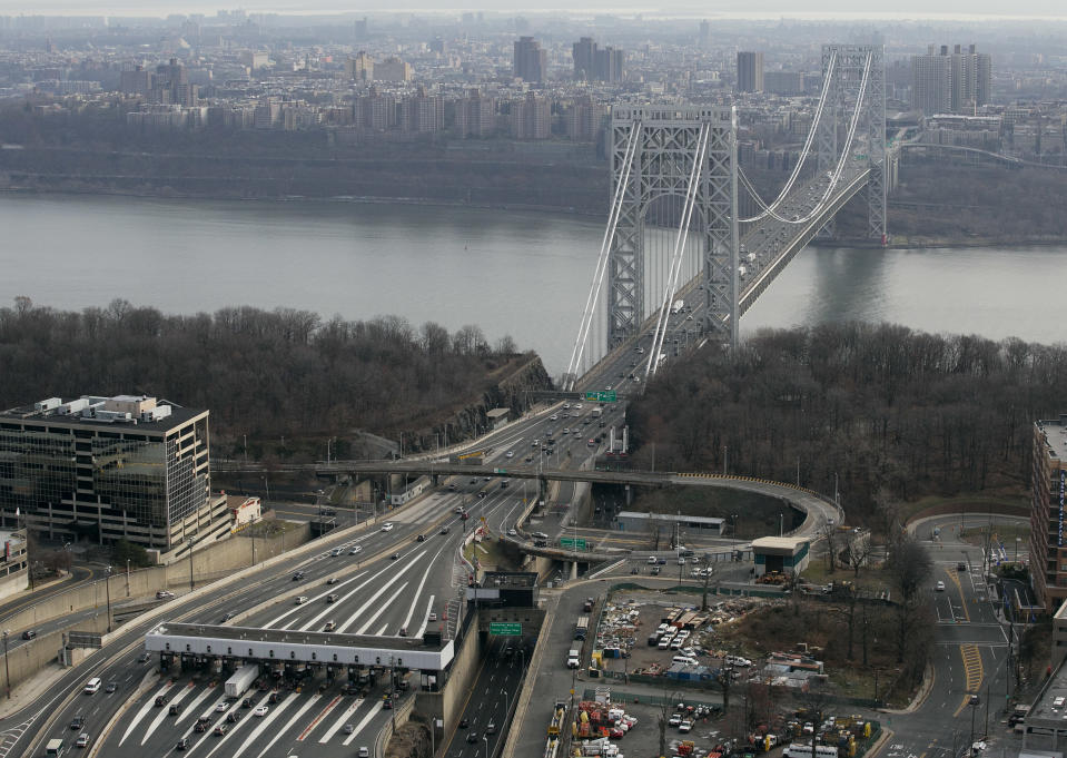 FILE - In this Dec. 1, 2013 file aerial photo, the tollbooth lanes, lower left, lead to the George Washington Bridge in Fort Lee, N.J. Many people have known little about Fort Lee until a political scandal centering on New Jersey Gov. Chris Christie enveloped the borough. Now for residents of the New York City bedroom community defined by both a feisty pride and frustration over the mixed blessings of proximity to the George Washington Bridge, the scandal is the reminder they did not need of how the bridge dictates the rhythm of everyday life. (AP Photo/Mark Lennihan, File)