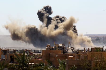 FILE PHOTO: Smoke rises from the last besieged neighborhood in the village of Baghouz, Deir Al Zor province, Syria, March 18, 2019. REUTERS/Stringer