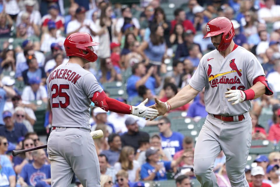 St. Louis Cardinals' Corey Dickerson (25) greets Paul Goldschmidt outside the dugout after Goldschmidt's homer off Chicago Cubs relief pitcher Sean Newcomb during the sixth inning of a baseball game against the Chicago Cubs Thursday, Aug. 25, 2022, in Chicago. (AP Photo/Charles Rex Arbogast)