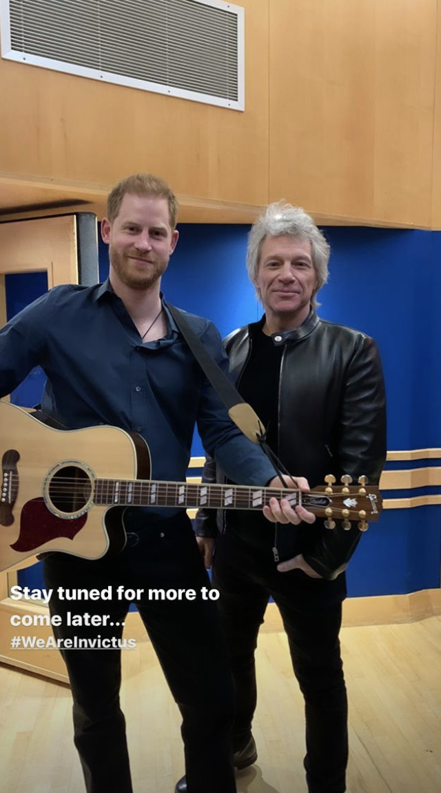 Prince Harry holding a guitar next to Jon Bon Jovi at Abbey Road Studios