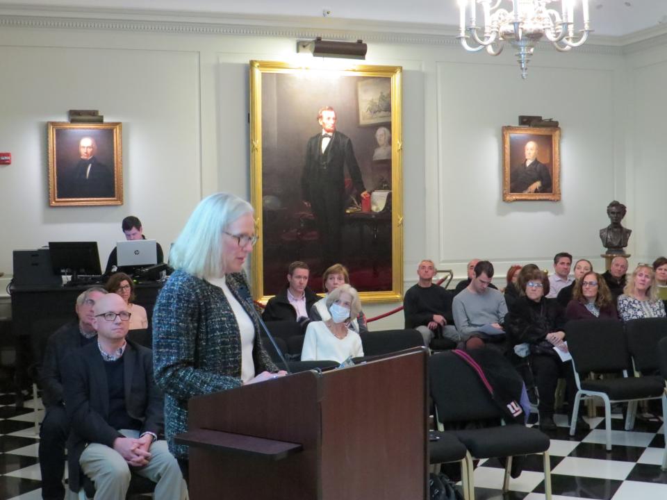 Hartley Dodge Foundation Trustee Anne MacCowatt announces the Abraham Lincoln painting, seen on the wall of the Madison borough council hall, will be loaned to the Smithsonian Institution National Portrait Gallery in Washington D.C.