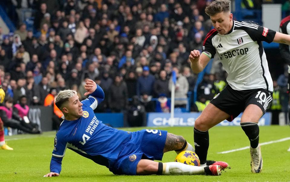 Chelsea's Enzo Fernandez challenges for the ball with Fulham's Tom Cairney