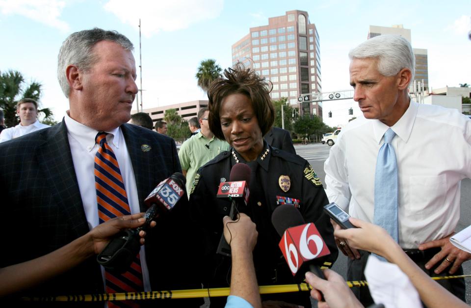 Florida Gov. Charlie Crist listens to Orlando police chief Val Demings, with Orlando mayor Buddy Dyer, on the scene in downtown Orlando, Fla. following a multiple shooting earlier in the day in an office building, Nov. 6, 2009. Crist was in Tampa at the time of the shooting and came to Orlando to offer support. 