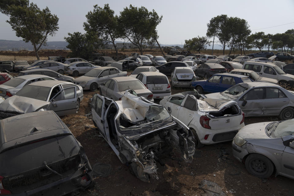 Illegal vehicles that was confiscated by Palestinian police, which are set to be destroyed as part of a wider crackdown on crime, are gathered at a scrap yard at the Beit Qad police station, north of the occupied West Bank city of Jenin, Sunday, Aug. 13, 2023. (AP Photo/Nasser Nasser)