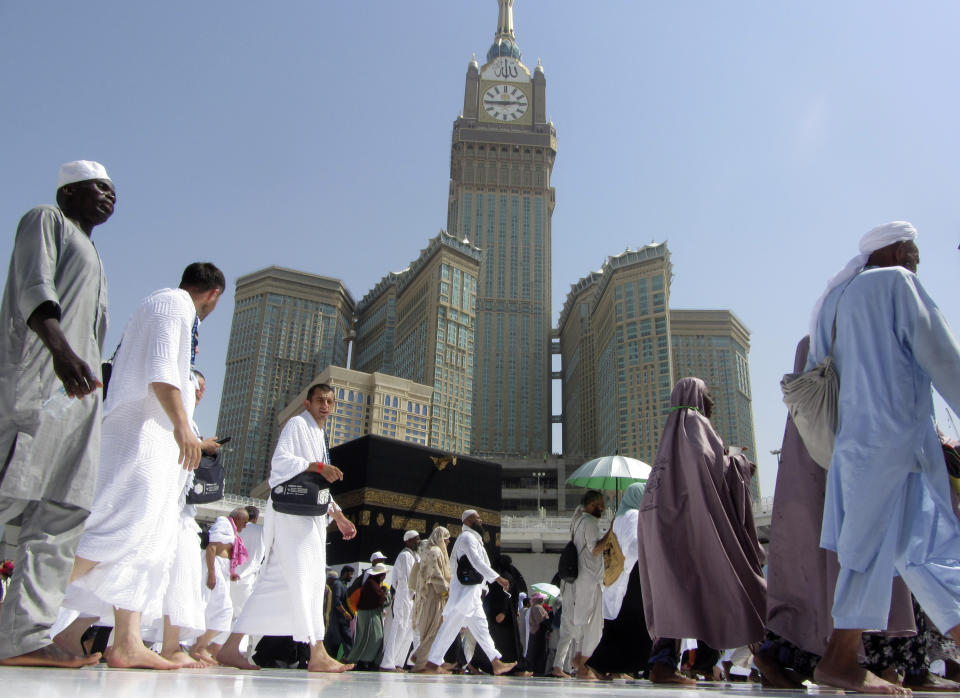 The tallest clock tower in the world with the world's largest clock face, atop the Abraj Al-Bait Towers, overshadows Muslim pilgrims as they circumambulate around the Kaaba, the cubic building at the Grand Mosque, in the Muslim holy city of Mecca, Saudi Arabia, Monday, Aug. 5, 2019. (AP Photo/Amr Nabil)