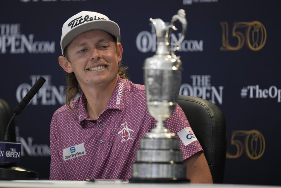 Cameron Smith, of Australia, looks at the claret jug trophy during a press conference after winning the British Open golf championship on the Old Course at St. Andrews, Scotland, Sunday July 17, 2022. (AP Photo/Alastair Grant)