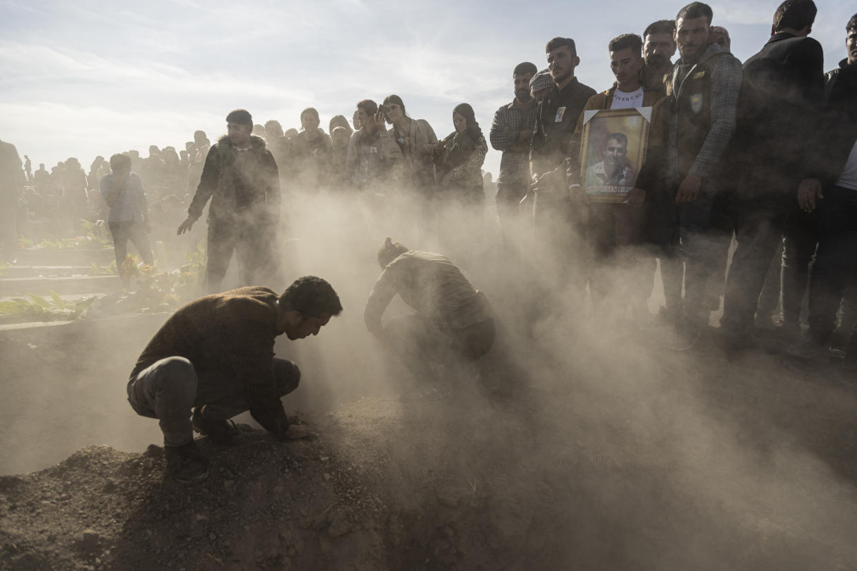 Syrian Kurds attend a funeral of people killed in Turkish airstrikes in the village of Al Malikiyah , northern Syria, Monday, Nov. 21, 2022. The airstrikes, which Turkey said were aimed at Kurdish militants whom Ankara blamed for a deadly Nov. 13 bombing in Istanbul, also struck several Syrian army positions in three different provinces along the border with Turkey. (AP Photo/Baderkhan Ahmad)