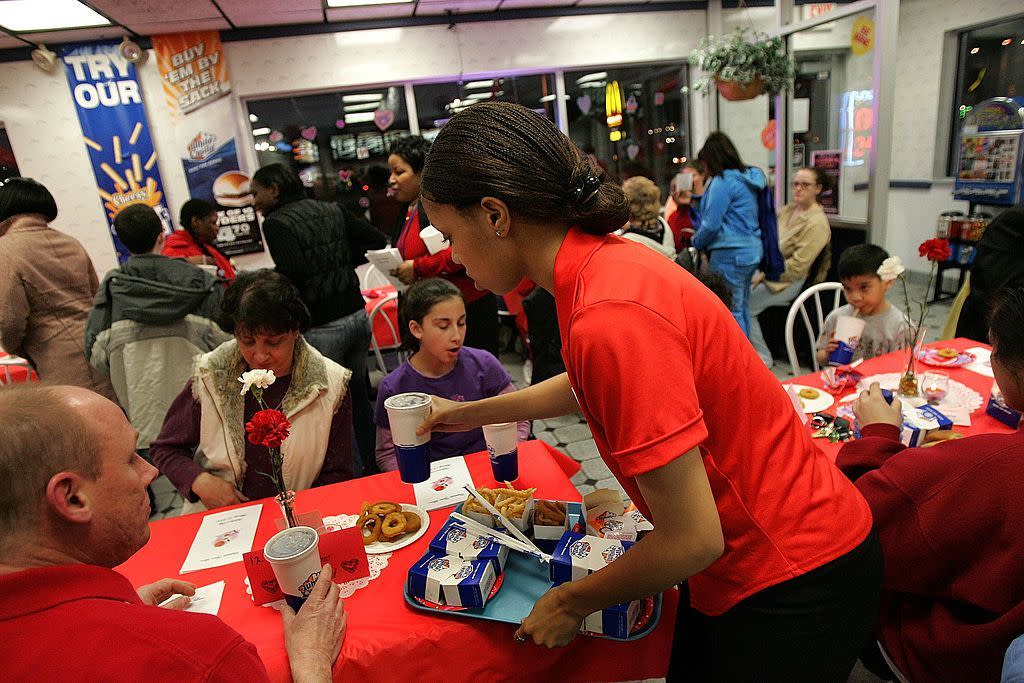 waitress danielle wright delivers a customers order in a white castle restaurant during a valentines day dinner