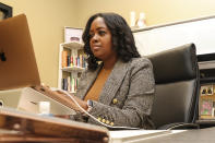 Moné Holder, senior director of advocacy and programs for Florida Rising, works at her desk in Jacksonville, Fla., Jan. 17, 2023. A protracted legal fight over how city council districts were drawn in Jacksonville, Florida, reflects an aspect of redistricting that often remains in the shadows. Political map-drawing for congressional and state legislative seats captures wide attention after new census numbers are released every 10 years. No less fierce are the battles over the way voting lines are drawn in local governments, for city councils, county commissions and even school boards. (AP Photo/Gary McCullough)