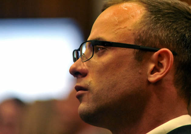 Oscar Pistorius cries as he listens to evidence being given in court at his own trial on 24 March 2014. (AP photo)