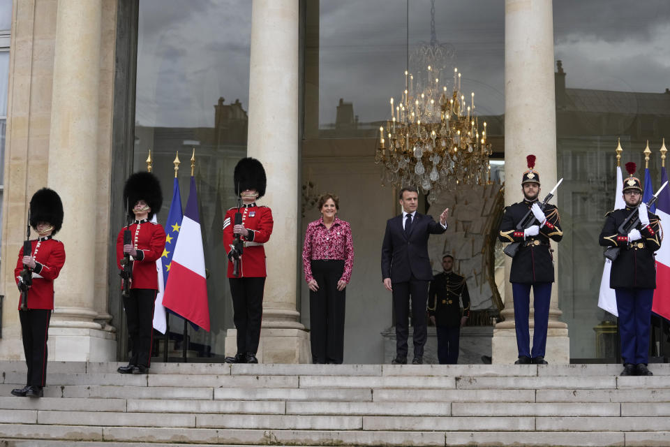 French President Emmanuel Macron and British ambassador to France Menna Rawlings stand with British soldiers and Republican Guards at the Elysee Palace, Monday, April 8, 2024 in Paris. Sixteen soldiers from No 7 Company Coldstream Guards and 32 members of the Gendarmerie Garde Republicaine mount guard at the Elysee palace as British troops join French guards in a special ceremony at the Elysee Palace to celebrate 120 years of "entente cordiale" between the longtime rival powers. (AP Photo/Thibault Camus, Pool)