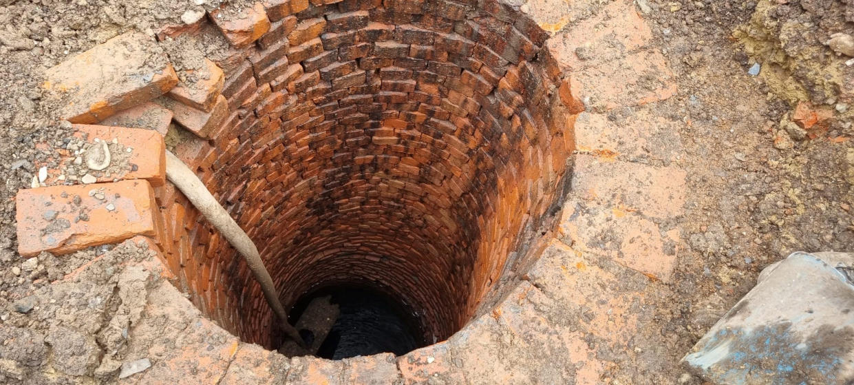 The top of the well. Photo released March 12 2024. See SWNS story SWLSwell. A family were left stunned after finding a â€˜mysteryâ€™ 22ft well beneath their home during building work to extend their kitchen. Mum Louise Watson, 45, said workmen unearthed the water reservoir below an old lean-to structure, which was attached to their 130-year-old three-bed terrace.The top of the brick-lined well, which was covered by a heavy slate slab, was discovered two feet (60cm) beneath the ground's surface.When the family opened a huge pit, they sent a camera down to inspect it and found it contained 6ft (1.8m) of 