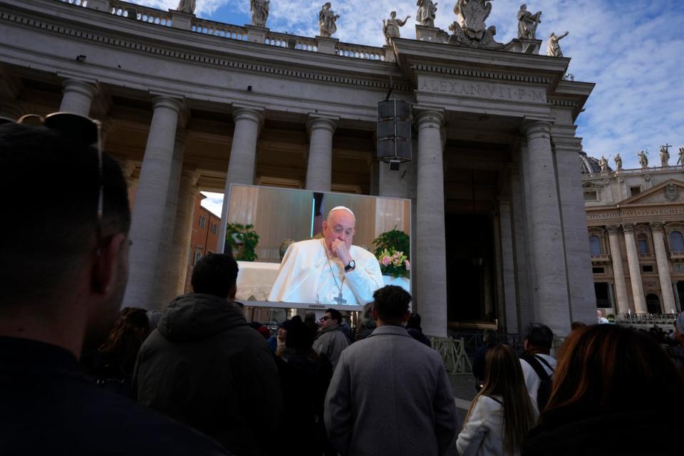 A giant screen broadcasts Pope Francis coughing during the Angelus noon prayer, from the chapel of the hotel at the Vatican grounds where he lives, Sunday, Nov. 26, 2023 (Copyright 2023 The Associated Press. All rights reserved)