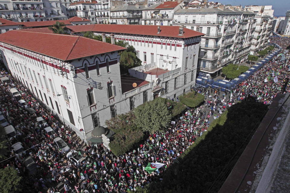 Algerian demonstrators take to the streets in the capital Algiers to protest against the government, in Algeria, Friday, Nov. 1, 2019. Police struggled Friday to contain thousands of Algerian demonstrators surging through the streets of the capital to protest next month's presidential election and celebrate 65 years since Algeria's war for independence from France. (AP Photo/Fateh Guidoum)