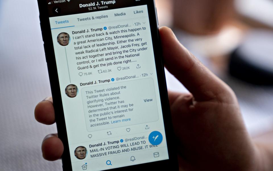 Donald Trump had some of his tweets hidden by Twitter in May after he broke their rules over violent speech - BLOOMBERG
