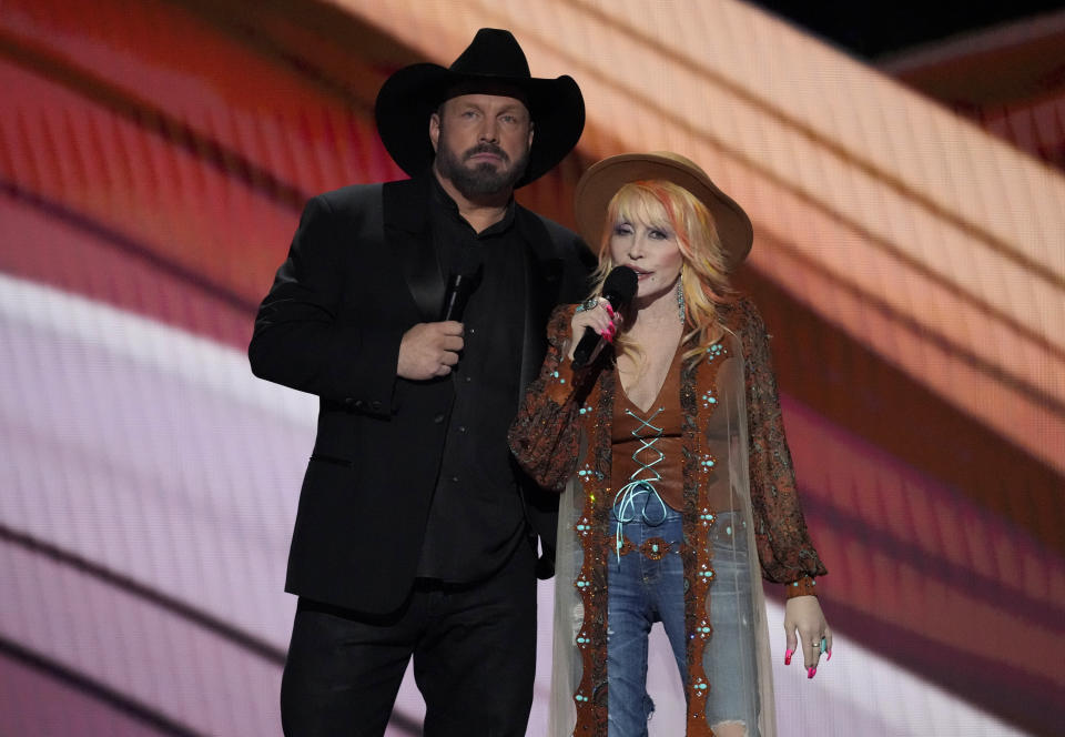 Hosts Garth Brooks, left, and Dolly Parton speak on stage at the 58th annual Academy of Country Music Awards on Thursday, May 11, 2023, at the Ford Center in Frisco, Texas. (AP Photo/Chris Pizzello)
