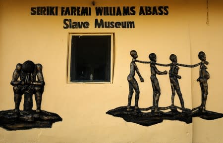 Bas-relief of shackled slaves is embedded in the wall of the Seriki Abass Slave Museum in Badagry
