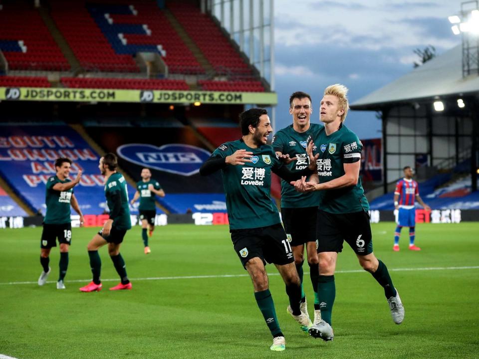 Ben Mee, right, celebrates scoring Burnley's winning goal: EPA